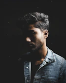 Artful silhouette of a man wearing a leather jacket, with sharp contrasts and deep shadows.