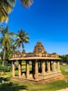 brown concrete temple near green trees during daytime