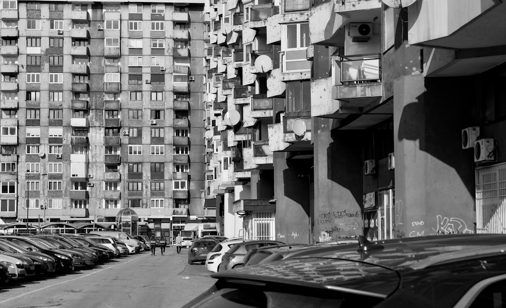 grayscale photo of cars parked on street