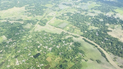 Aerial view of a lush green rural land with clear boundaries and a small river nearby.