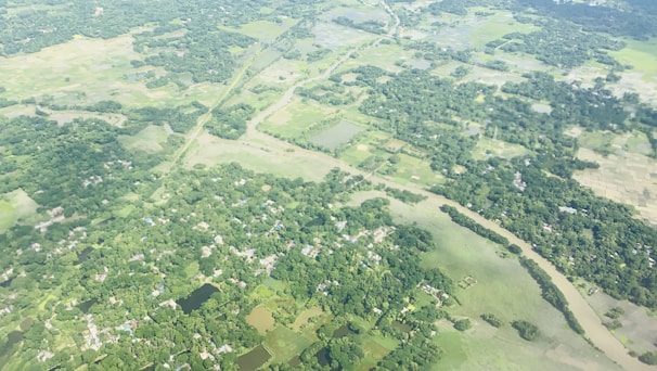 A sweeping aerial view of lush green land parcels bordered by winding rivers.