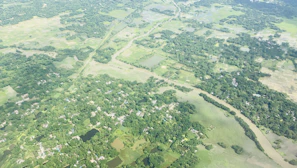 Aerial view of a lush green landscape with winding rivers and small community clusters forming natural networks.