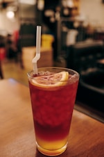 clear drinking glass with red liquid and ice