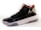 A high-top sneaker with a glossy black finish, featuring mesh panels and red accents on the interior lining. The shoe has a white midsole with a textured pattern and a translucent section on the heel. A distinctive logo is present on the side.