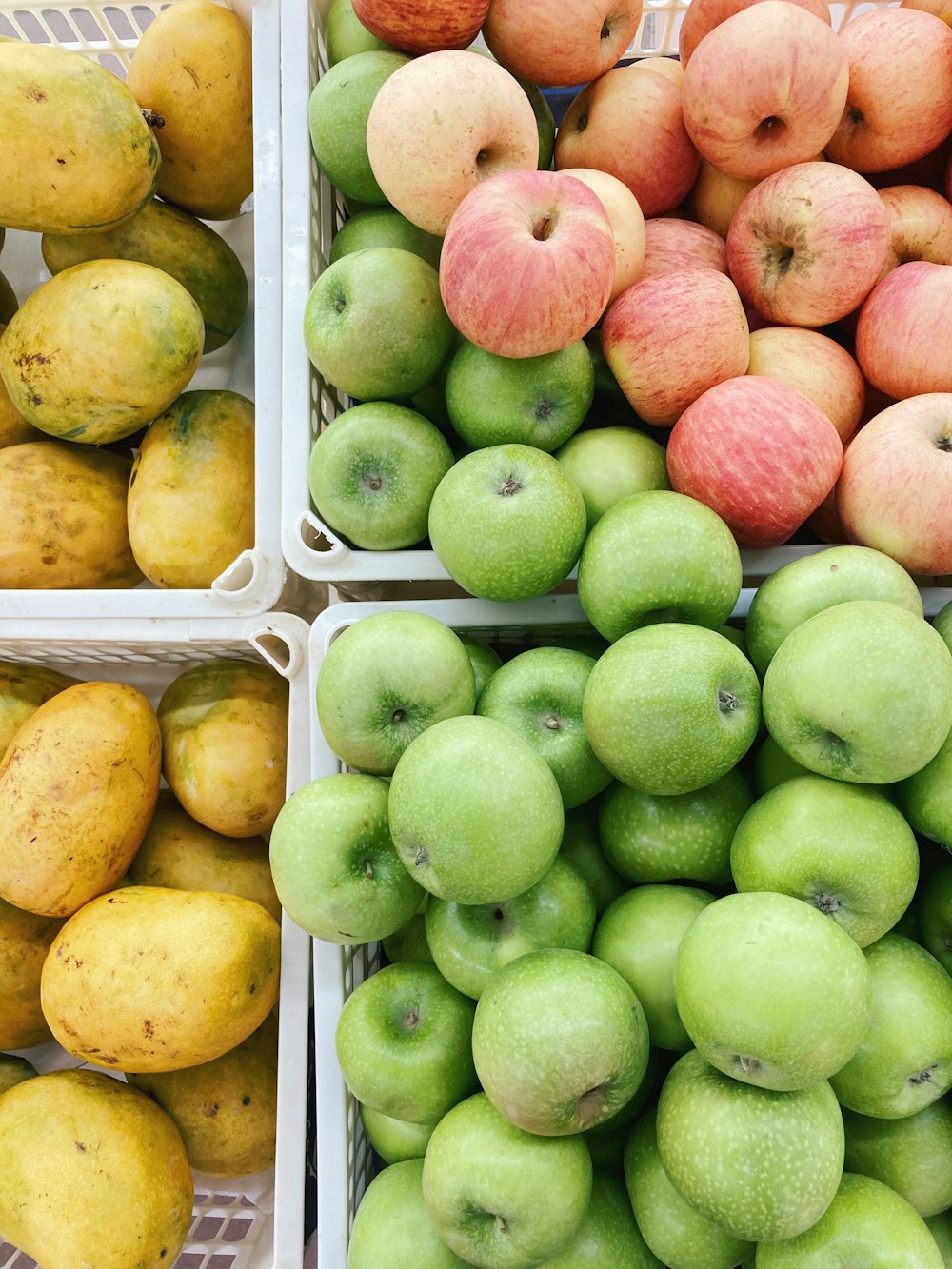 red and green apples on white plastic container