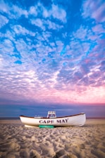 white and blue boat on beach under blue sky New Jersey