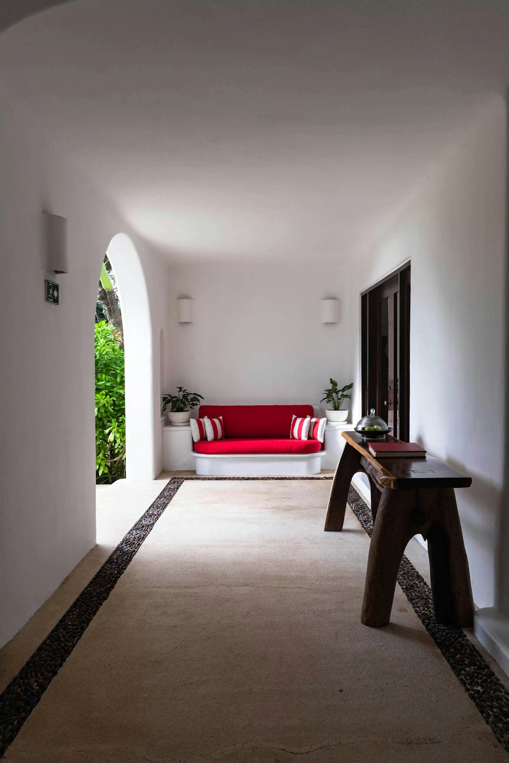 brown wooden table near red couch