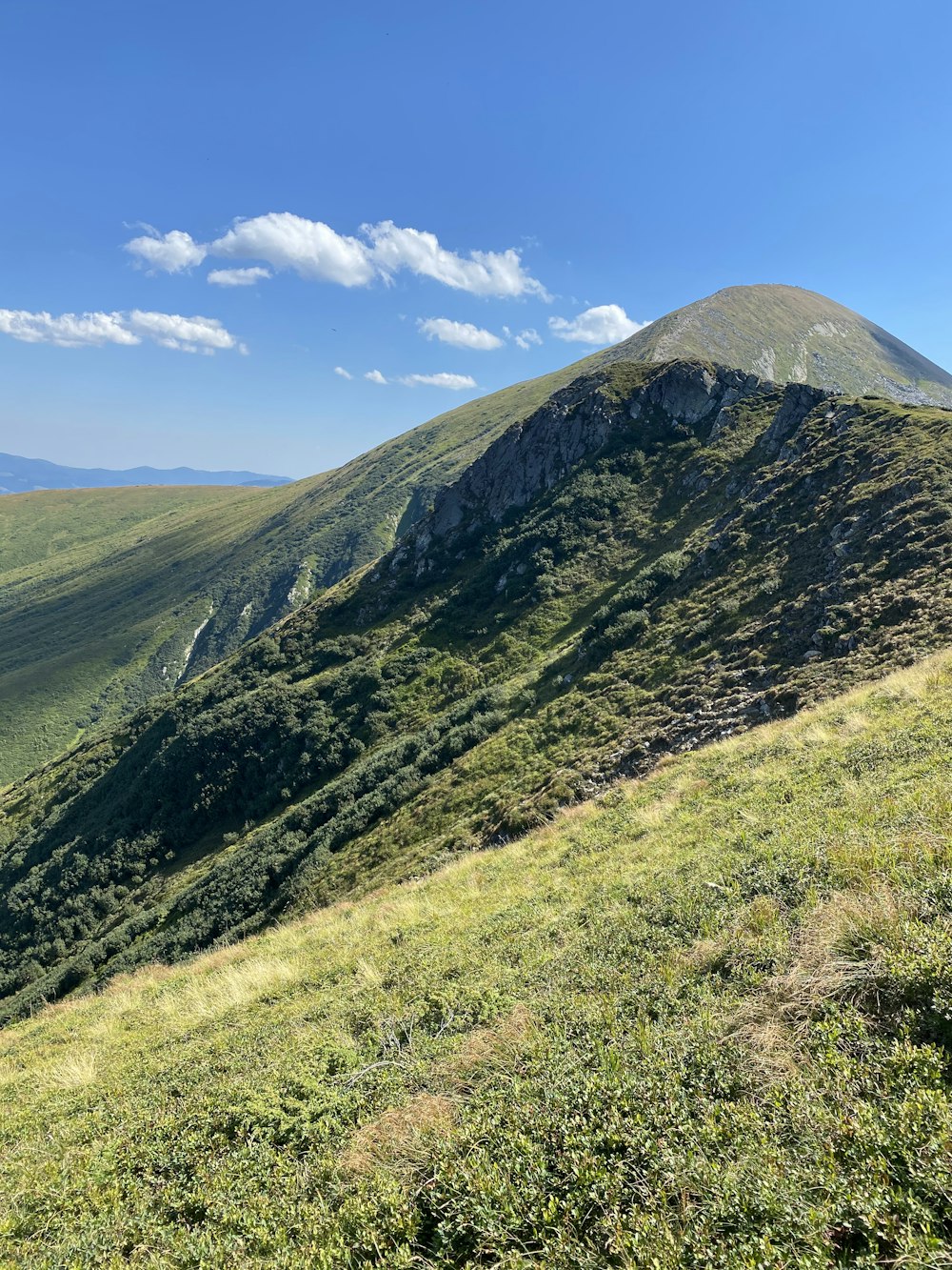 green and brown mountain under blue sky during daytime