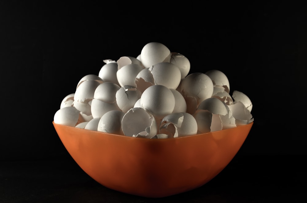 white egg on orange bowl
