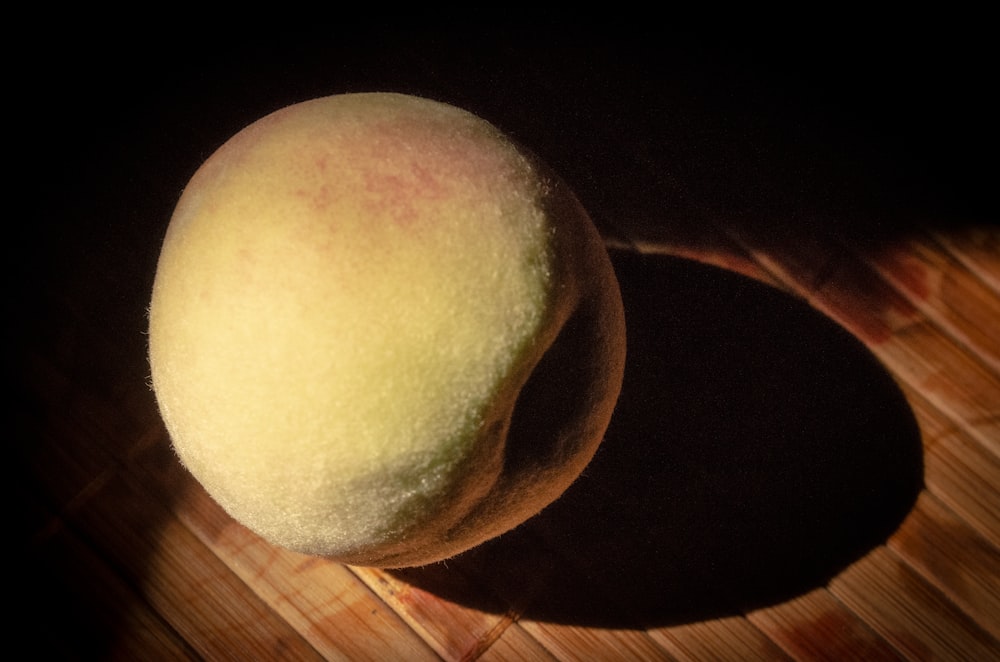 brown round fruit on brown wooden table