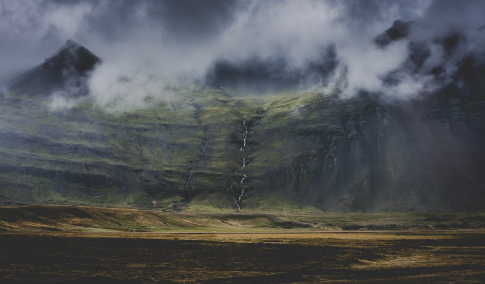 green and brown mountain under white clouds