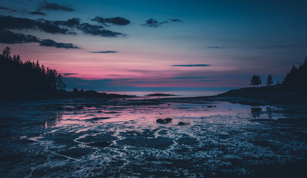 body of water under cloudy sky during daytime