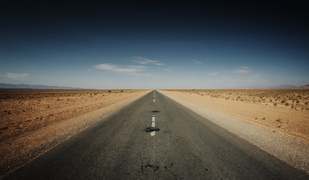 gray asphalt road under blue sky during daytime