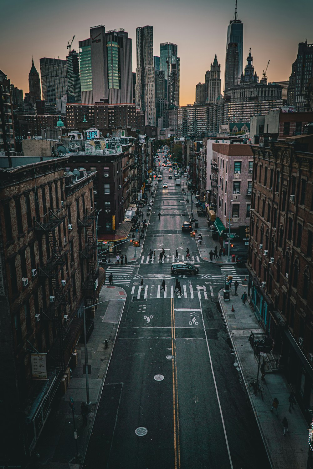 cars on road between high rise buildings during daytime