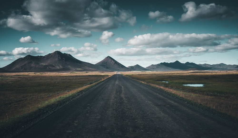 gray asphalt road under blue sky during daytime