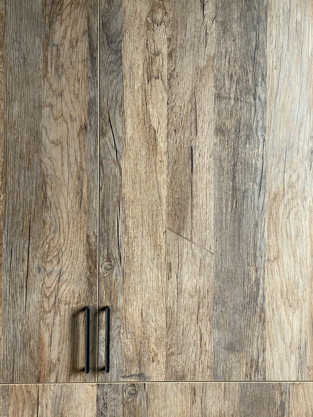 black metal door hinge on brown wooden surface