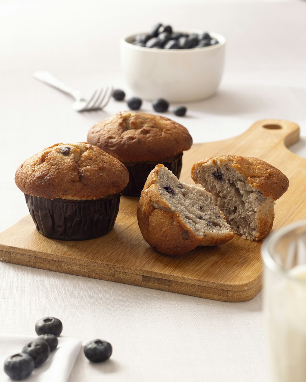 three brown cookies on brown wooden chopping board