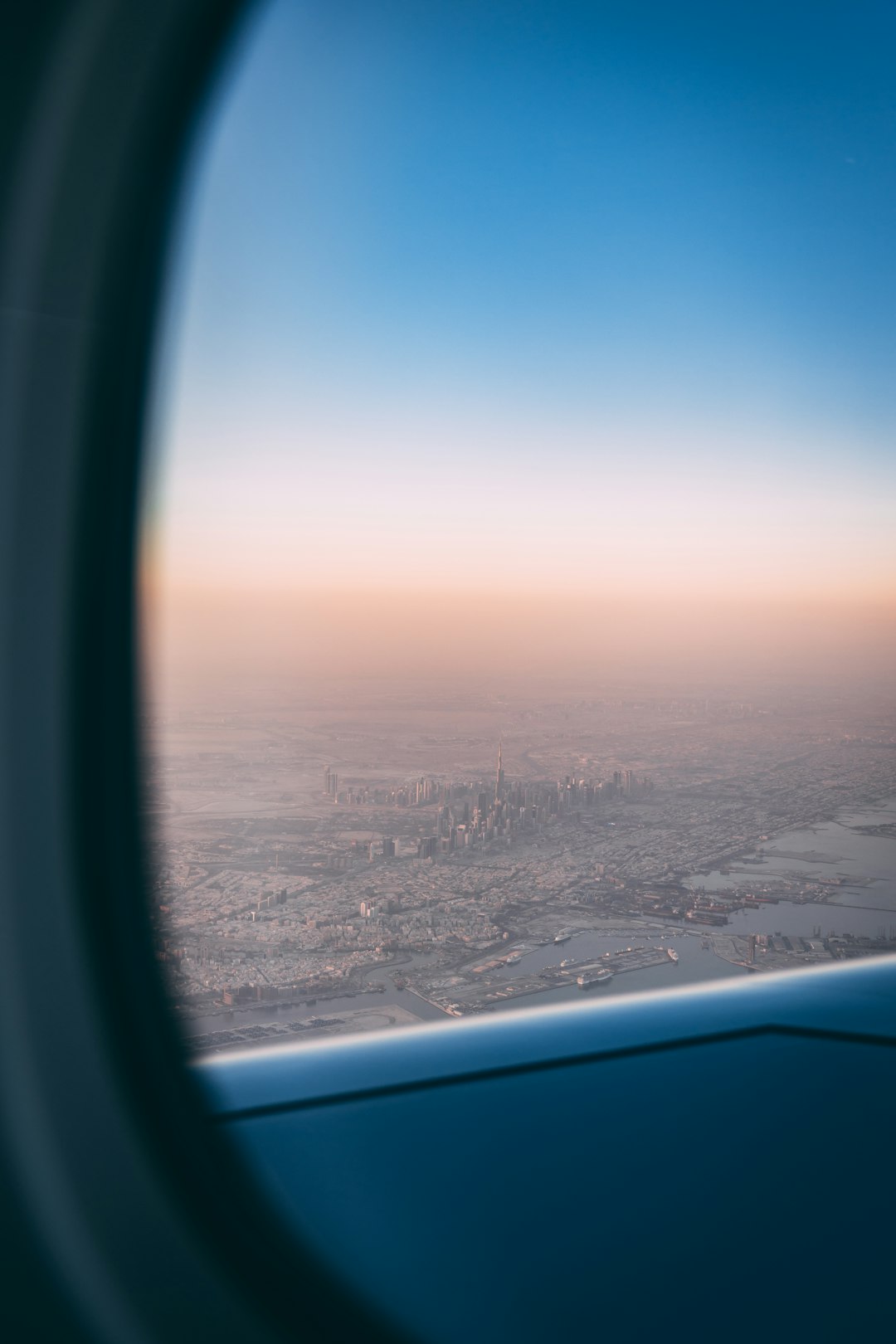 airplane window view of city during daytime