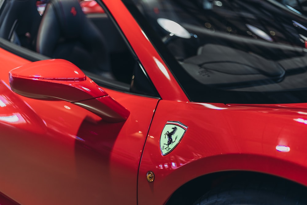 red ferrari car in close up photography