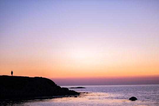 silhouette of mountain beside body of water during sunset in Varberg Sweden