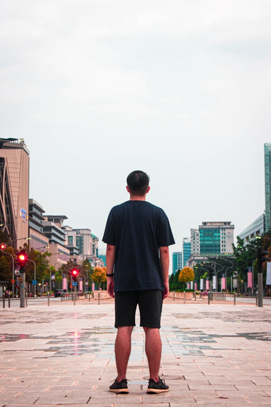 man in black long sleeve shirt standing on gray concrete floor during daytime in Putrajaya Malaysia