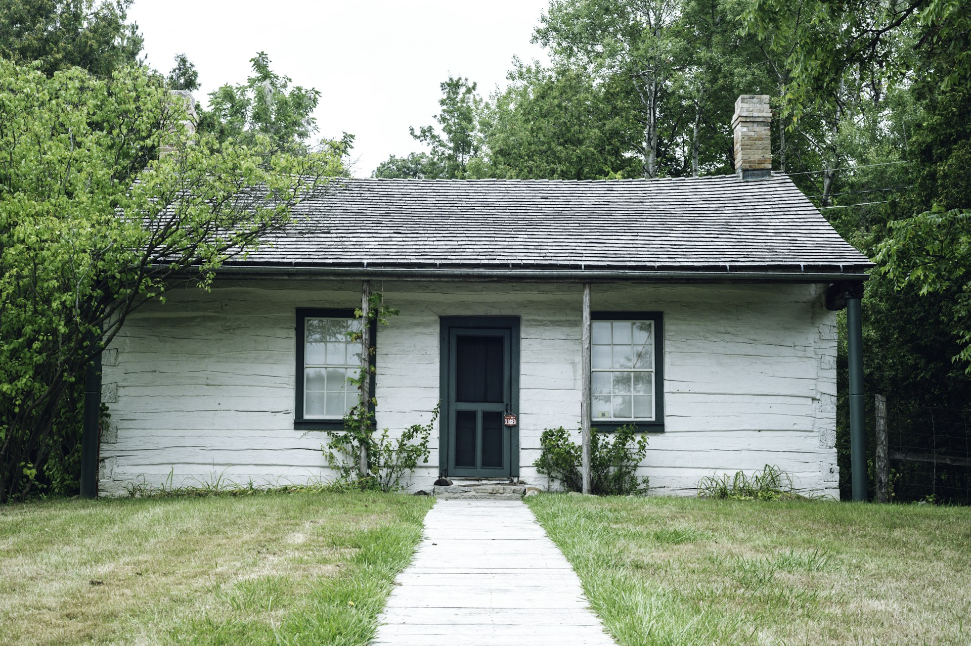 white wooden house with green grass lawn