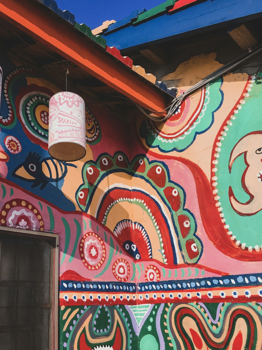 red and white wall with graffiti