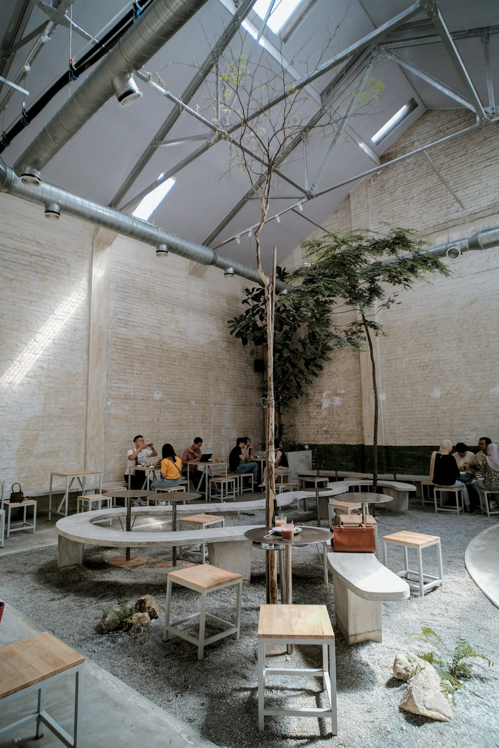 people sitting on white chairs near brown concrete building during daytime