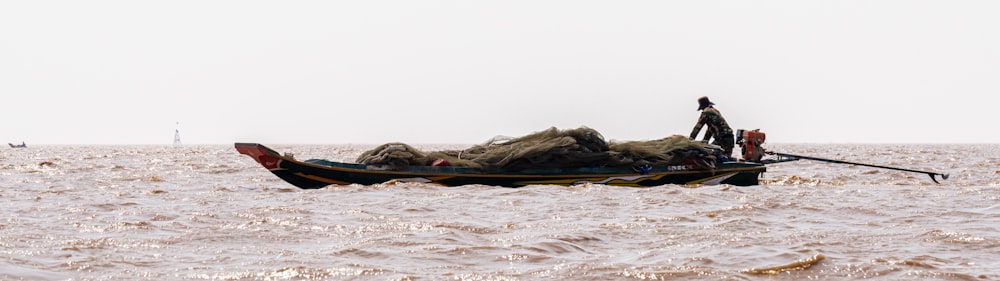 brown and green boat on sea during daytime