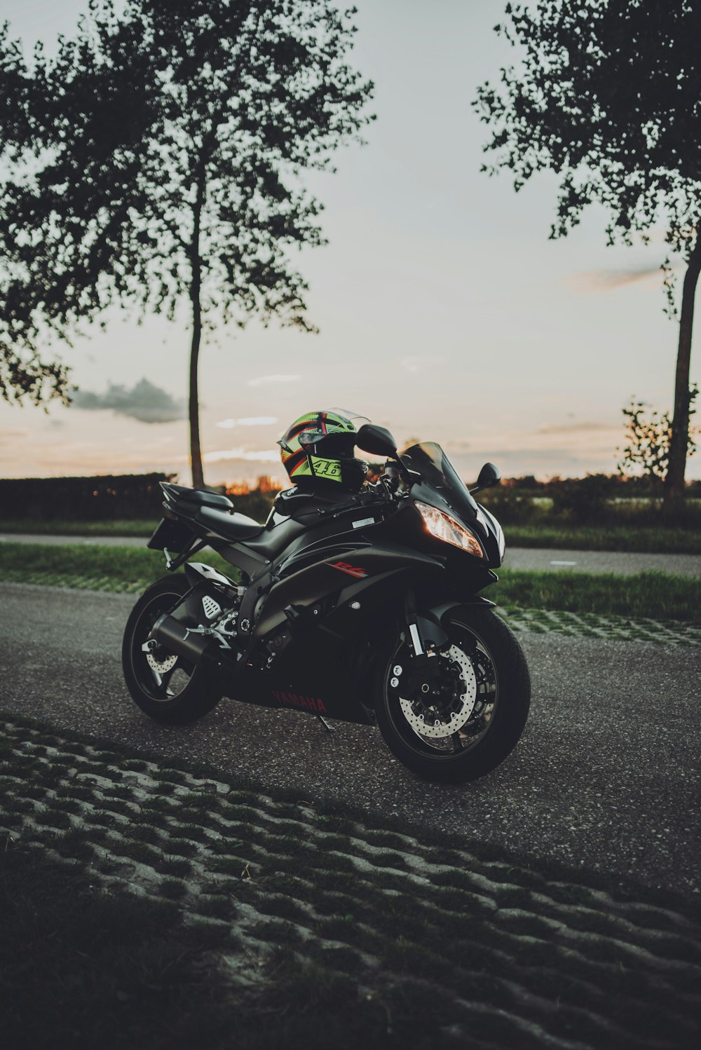 black sports bike parked on road during daytime