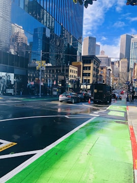Cityscape with electric delivery vans moving through bike lanes.