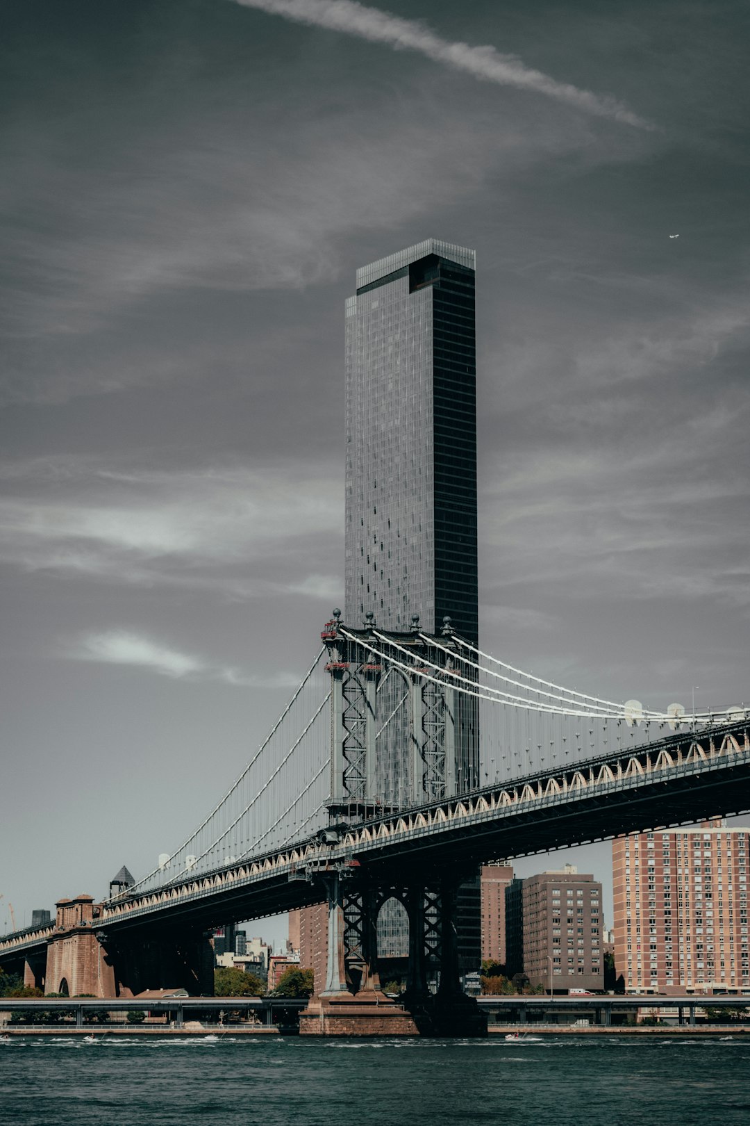 gray concrete bridge under gray clouds