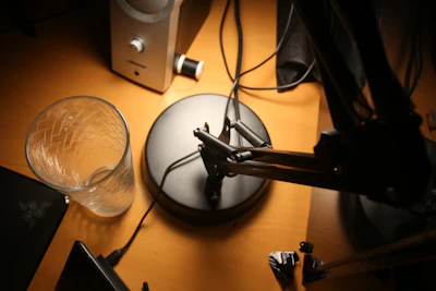 black and silver microphone on brown wooden table