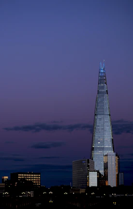 A panoramic view of a sleek, modern skyscraper in Baghdad bathed in evening light.