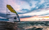 yellow and white sail boat on sea during daytime
