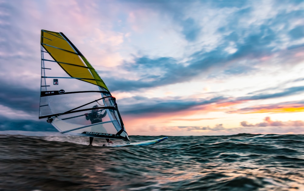 yellow and white sail boat on sea during daytime