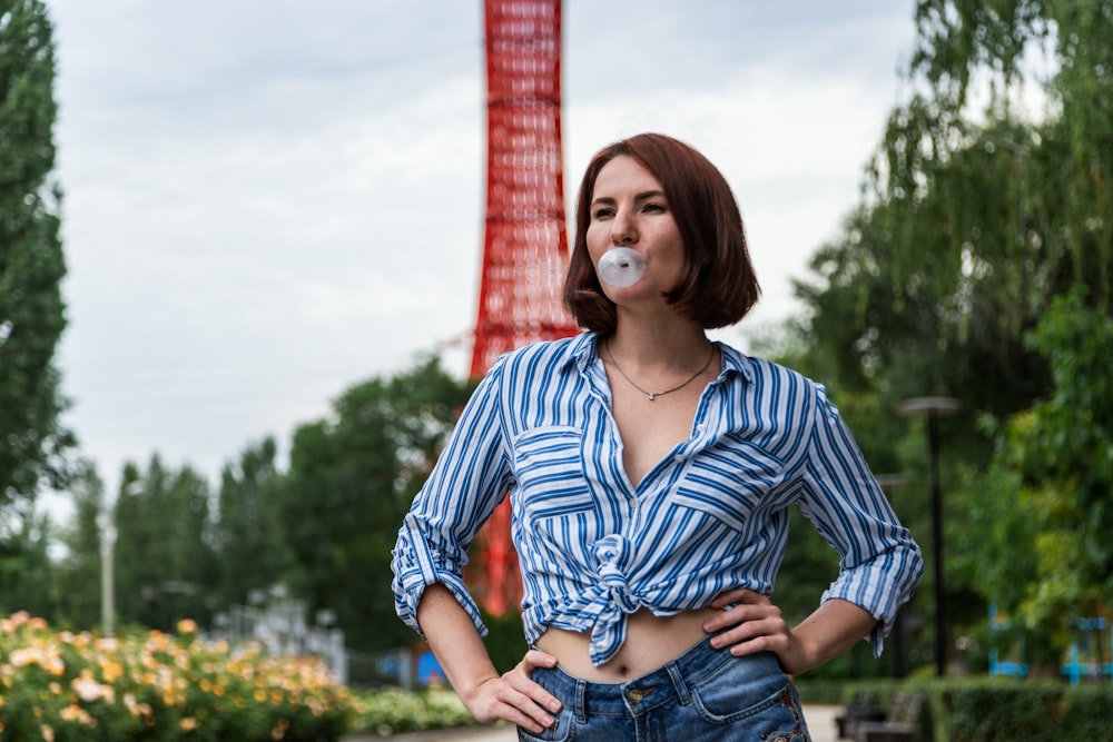 woman in blue and white striped long sleeve shirt and blue denim jeans