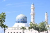 A serene mosque with a clear blue sky, symbolizing peace and community.