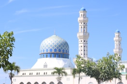 A serene mosque with a clear blue sky, symbolizing peace and community.