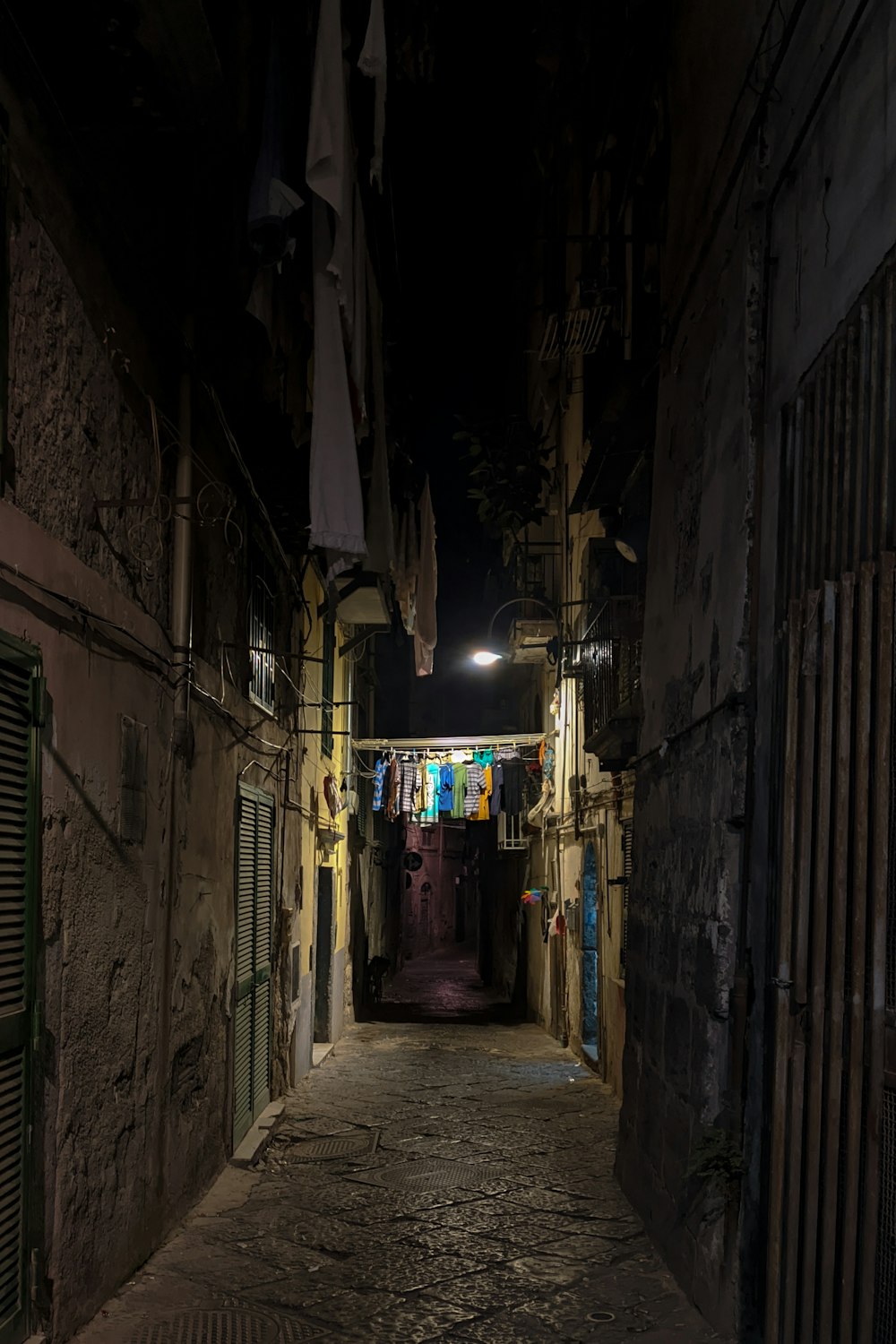 alley with light turned on during nighttime