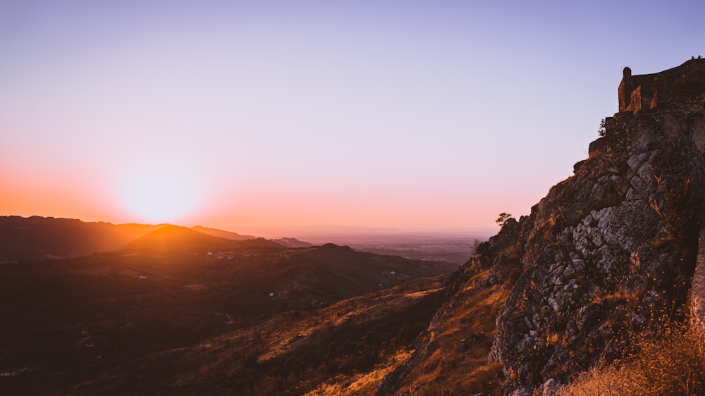 brown rocky mountain during sunset