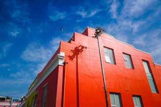 The exterior of a small business building featuring crisp, fresh paint in red, white, and blue shades.