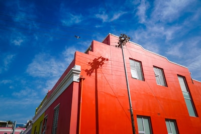 The exterior of a small business building featuring crisp, fresh paint in red, white, and blue shades.