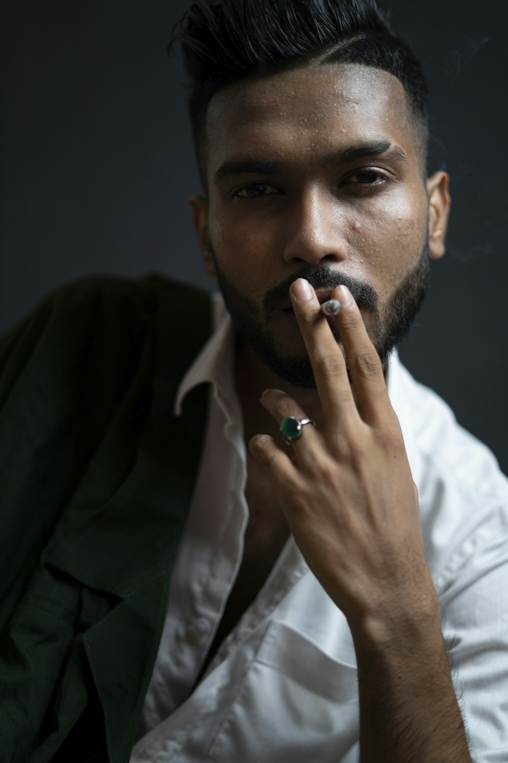 man in white dress shirt smoking cigarette