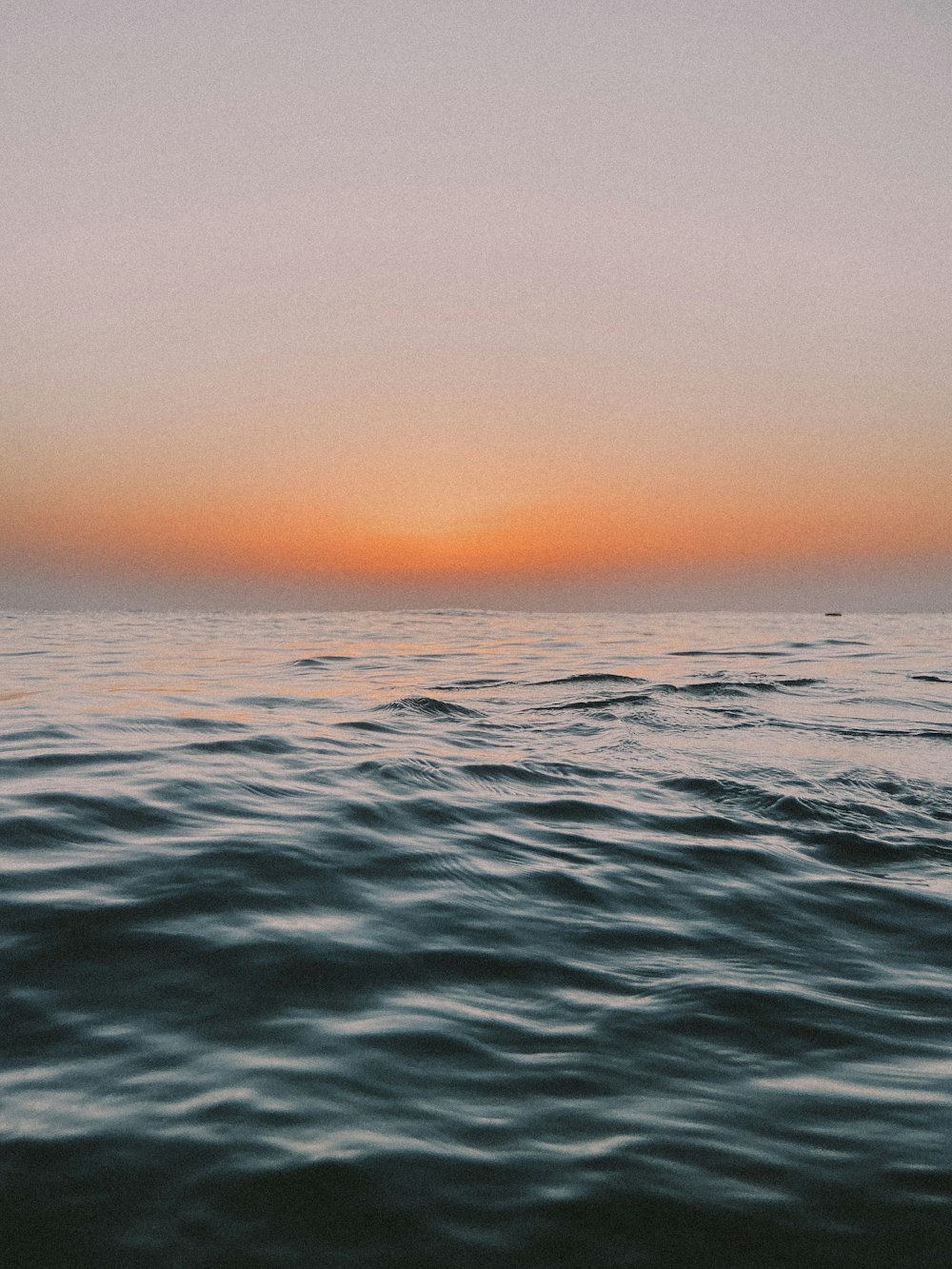 body of water during sunset