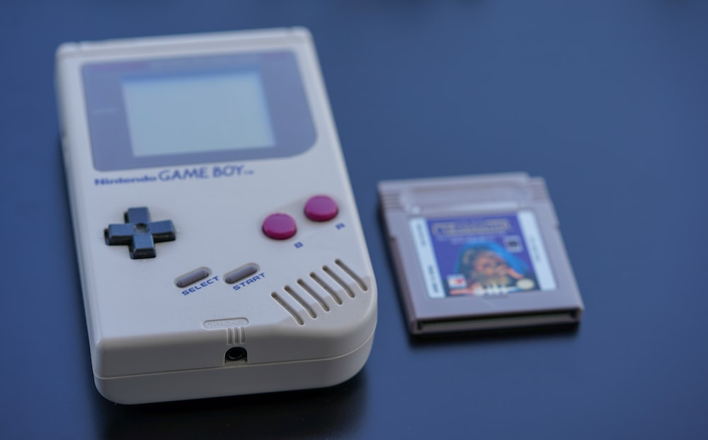 white nintendo game boy on blue table