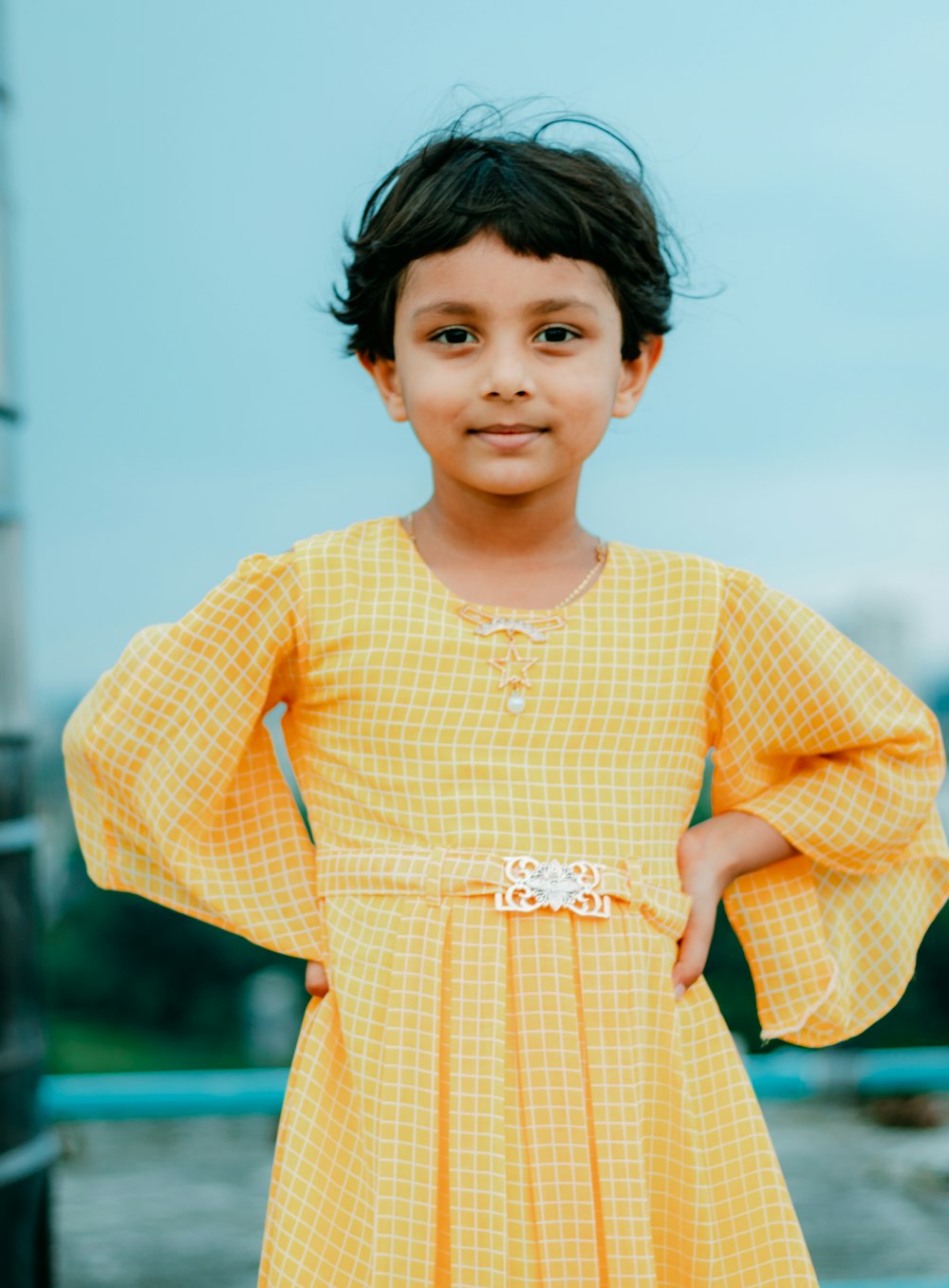 girl in yellow and white checkered dress