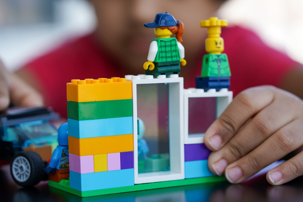 person holding lego blocks toy