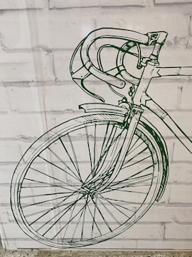 Designer sketching a new bicycle model on a wooden desk.