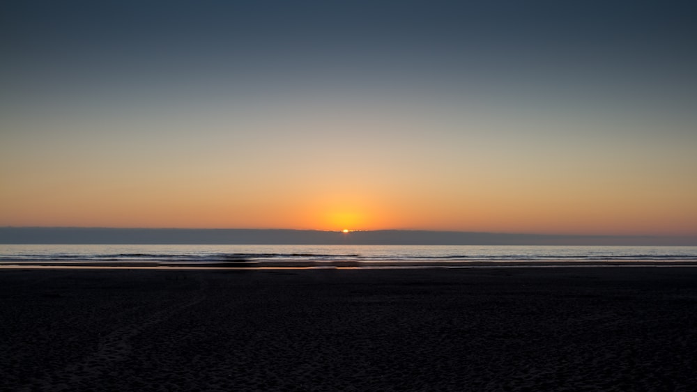 body of water during sunset